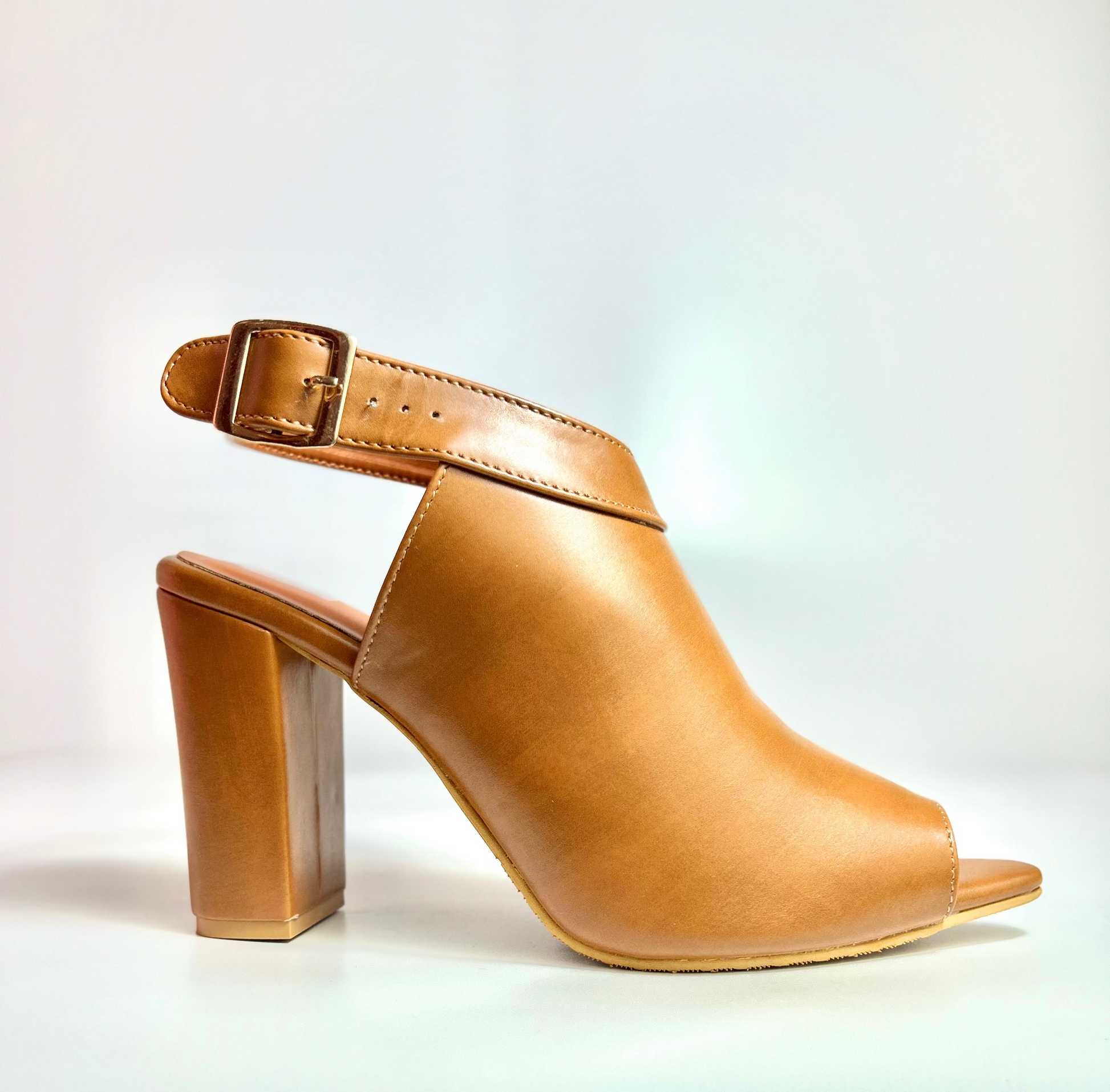 Tan high-heeled shoe on a white background
